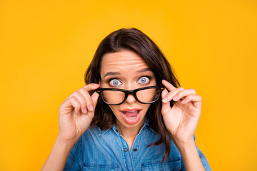 Close up photo of astonished girl touch her specs hear unbelievable news about black friday shout wow omg wear stylish youth outfit isolated over yellow color background