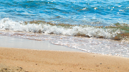 sandy beach and blue sea wave. Beautiful natural background. Tourism and travel.