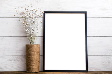 Mockup of blank black frame poster on wall