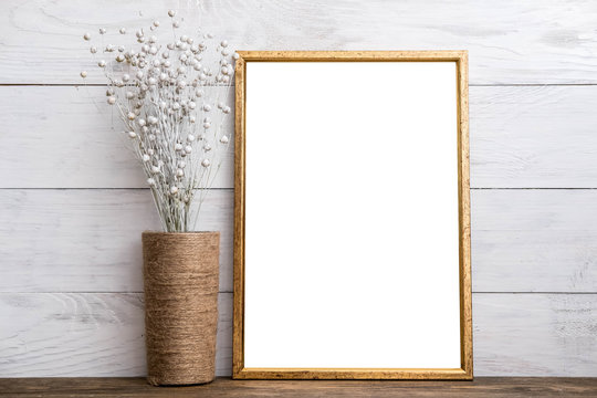 Mockup of blank brown frame poster on wall with decor