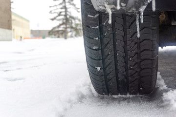 Car tire in snow outdoors in Winter