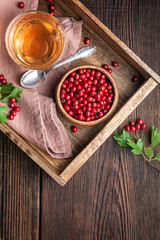 A cup of hot hawthorn tea made from freshly picked berries, herbal medicine for heart health with...