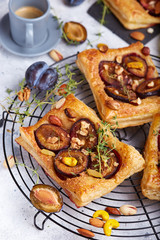 Delicious puff pastries with plums, honey, nuts, cinnamon and thyme