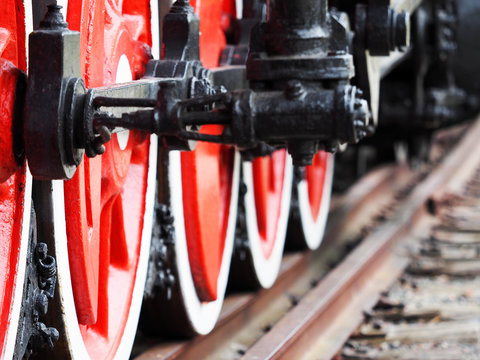 Railroad, train. Old diesel locomotive closeup, wheels on rails, red and black