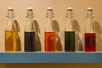 Glass bottles with multi-colored liquids.