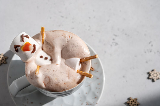 Hot chocolate with melted marshmallow snowman