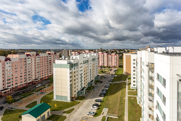 Panoramic view on new quarter high-rise building area urban development residential quarter in the cloudy autumn from a bird's eye view. life in a big city