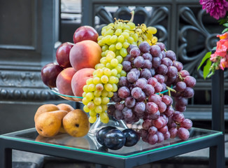 Still life of grapes, apples, pears and plums.