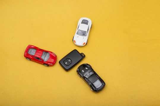 Collection of Multi Colored Modern Cars with with remote on yellow background