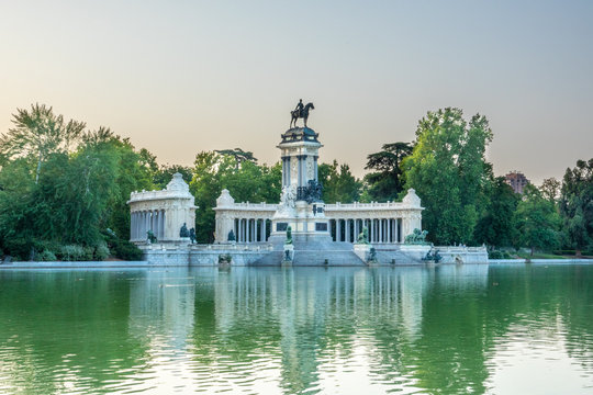 A lake and a Monument to Alfonso XII (build in 1922) in the public Park of the Pleasant Retreat (Parque del Buen Retiro) in Madrid, Spain