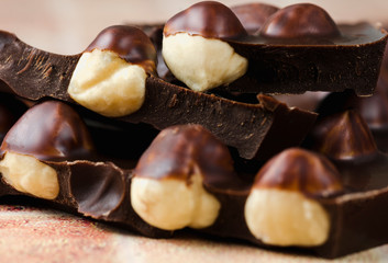 Whole hazelnut in dark chocolate close up