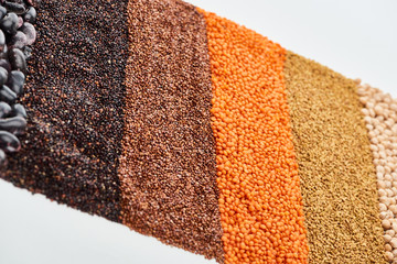 uncooked red lentil, buckwheat, quinoa, and chickpea isolated on white