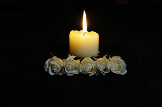 Beautiful%20White%20roses%20with%20a%20burning%20candle%20on%20the%20dark%20background.%20Funeral%20%20flower%20and%20candle%20on%20table%20against%20black%20background,%20copy%20space.%20Covid-19%20%20Funeral%20symbol.%20Mood%20and%20Condolence%20card%20concept%20Stock%20Photo%20|
