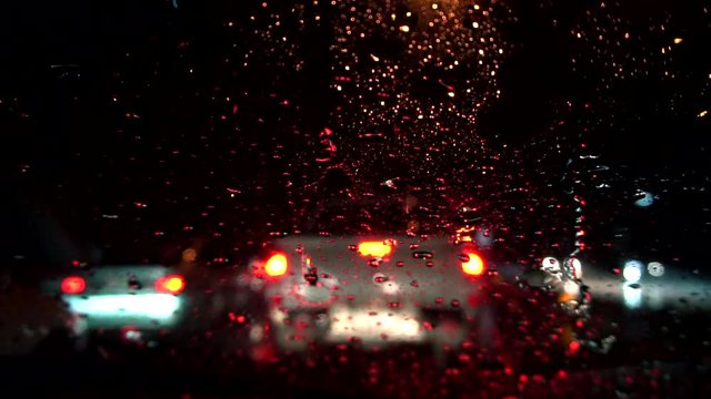 Heavy raining night traffic view from inside a car
