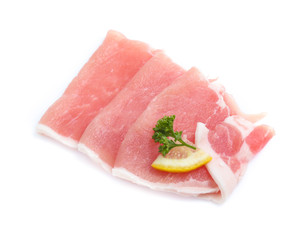 Raw pork meat with parsley herb leaves isolated on white background