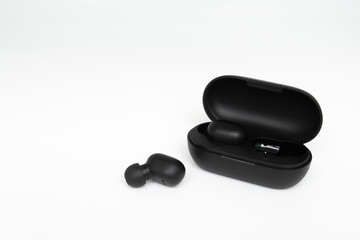 Fototapeta na wymiar Black true wireless earbuds with power bank case on the white isolated background