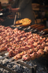 barbecue meat on skewers. grilled meat on open grill. street food