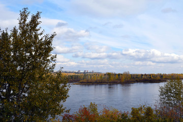 The wide Yenisei river. Krasnoyarsk region. Nature Of Siberia. Beautiful autumn landscape. A lot of yellow leaves on the trees.