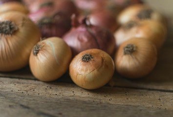 Fresh , organic onions in basket on old wooden table