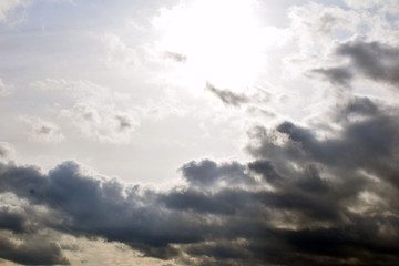 The sun peeks out from behind the clouds. The stormy sky. Dramatic scenery.