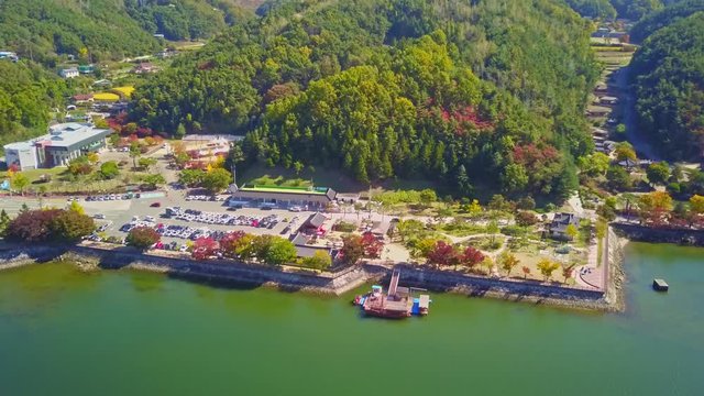 Aerial video of Wolyeonggyo bridge is located in the midst of Nakdong river in the morning during Autumn season at Andong city, South Korea.