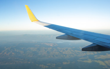 Wing of an airplane on blue sky