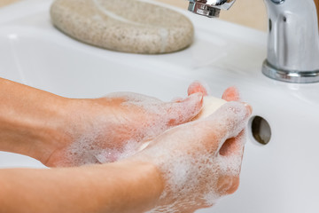 Fototapeta premium Hygiene concept. Washing hands with soap under the faucet with water