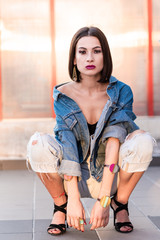 Portrait of young fashionable woman wearing jeans