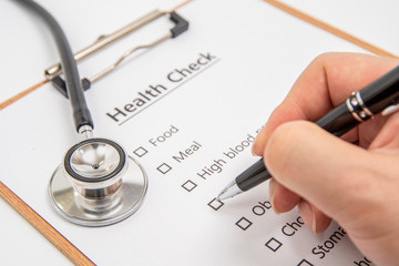 Health concept with clipboard and health check related items.