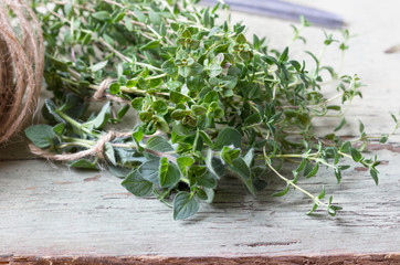 Sprigs of thyme on a wooden background.