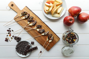 apple chocolate vegan snack from above in a white wooden table 