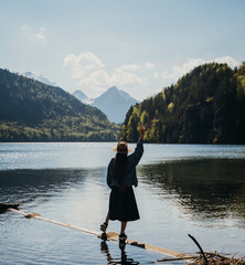 The girl in the dress and hat of the lake in the mountains