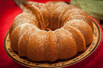 Christmas bundt cake on festive platter with red tablecloth