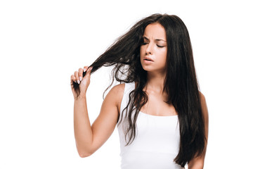 Fototapeta premium worried brunette beautiful woman with straight and curly hair isolated on white