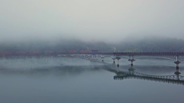 Aerial video of Wolyeonggyo bridge is located in the midst of Nakdong river in the morning during Autumn season at Andong city, South Korea.