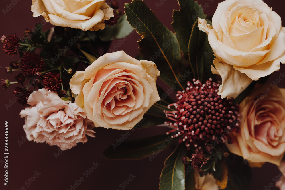 Wall mural close up shot of floral arrangement with roses, carnations and protea