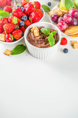 Vegan food for breakfast, snack. Homemade Sweet Hummus with strawberries, apple, crackers, grapes. Variations of different hummus dessert dips - vanilla, chocolate, caramel.