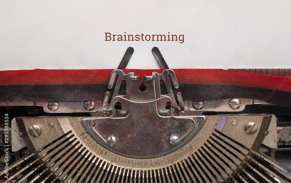Fototapete text of brainstorming on paper with old manual typewriter top view, copy space