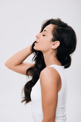 side view of brunette beautiful woman with closed eyes and long healthy hair isolated on grey