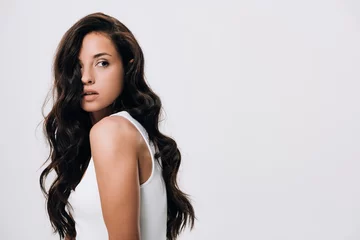 Fotobehang brunette beautiful woman with long healthy and shiny hair looking away isolated on grey © LIGHTFIELD STUDIOS