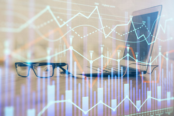 Stock market graph and table with computer background. Double exposure. Concept of financial analysis.