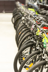 Bikes. A row of bikes in the shop. Large selection in the sports hypermarket.