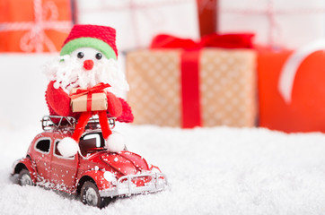 New year Santa delivering presents by car on background