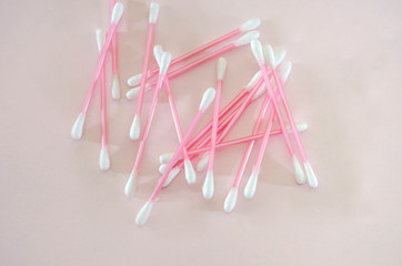 ear sticks on a pink background. View from above.