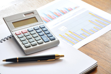 calculator and graph paper with business concept