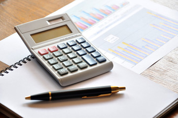 calculator and graph paper with business concept