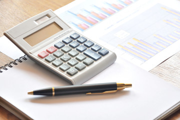calculator and graph paper with business concept