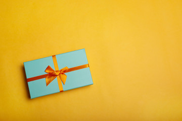 Christmas gift box on yellow background flat lay