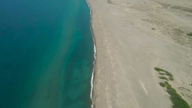 Aerial view of beautiful lonely beach and Paoay sand dune. Philippines, Luzon. Ilocos Norte. Large island with a wide beach.