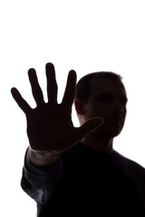 Hand young man covers his face, protest - silhouette, concept